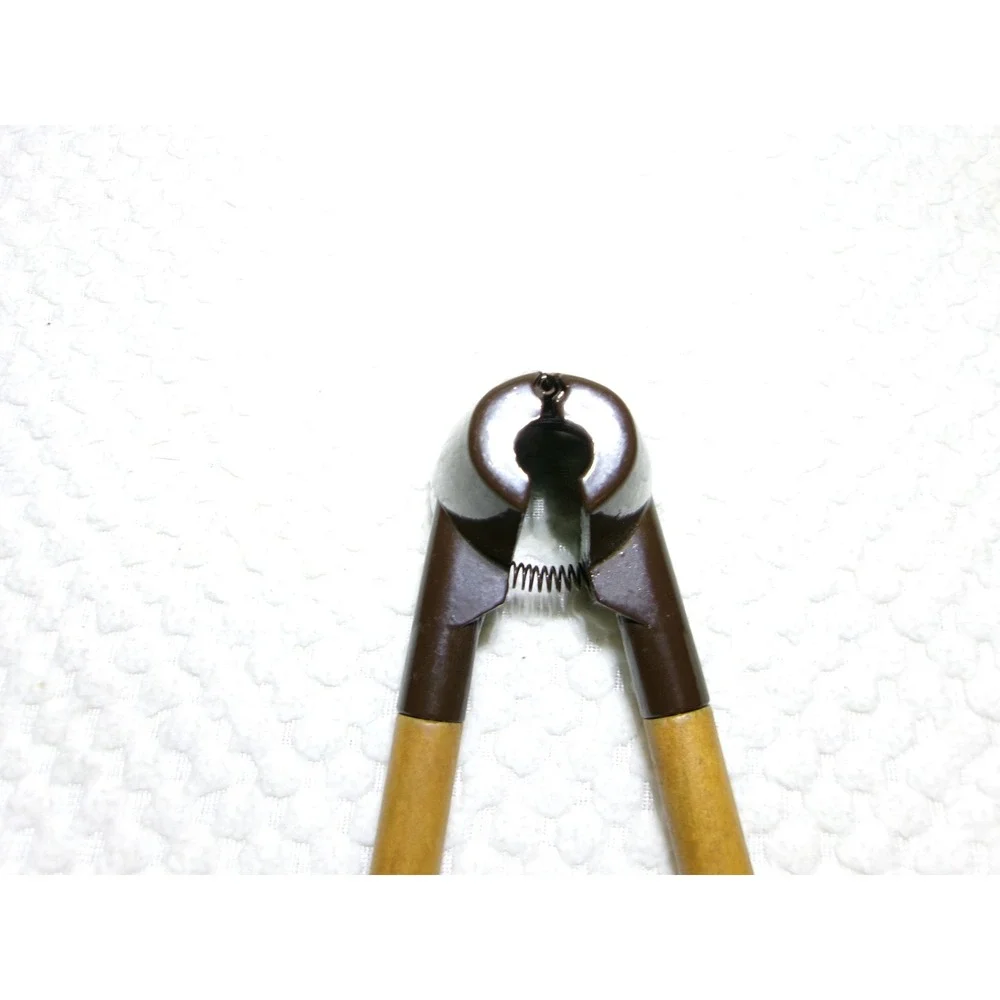 Vintage Spring Loaded Nutcracker‎ Brown Metal with Wood Handles Conical Design